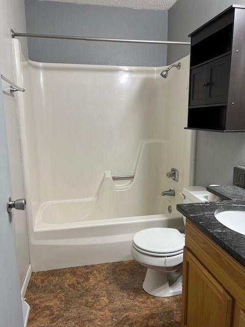 711 SW 2nd St, Stuart, IA 50250 - full bath featuring bathing tub / shower combination, vanity, and toilet