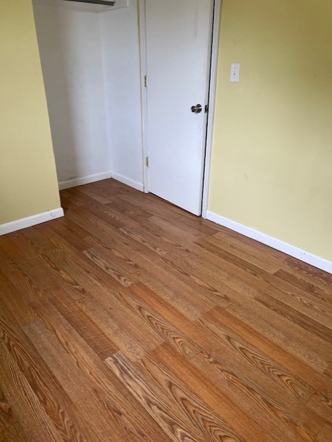 711 SW 2nd St, Stuart, IA 50250 - unfurnished bedroom with wood finished floors and baseboards