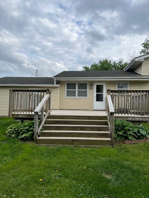 711 SW 2nd St, Stuart, IA 50250 - rear view of house with a deck and a lawn