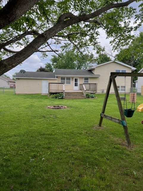 711 SW 2nd St, Stuart, IA 50250 - rear view of house with a deck and a lawn