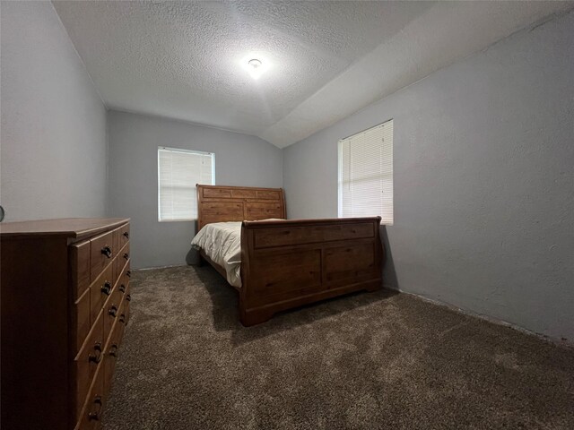 205 N 2nd St, Mystic, IA 52574 - bedroom with carpet floors, a textured ceiling, vaulted ceiling, and a textured wall