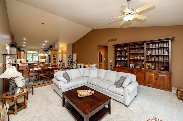 3739 155th Ct, Urbandale, IA 50323 - living room featuring vaulted ceiling, ceiling fan, and light colored carpet
