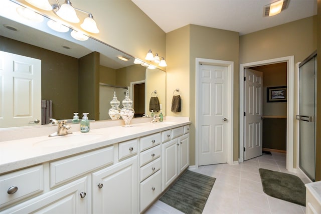 3739 155th Ct, Urbandale, IA 50323 - bathroom featuring double vanity, a stall shower, tile patterned floors, baseboards, and a chandelier