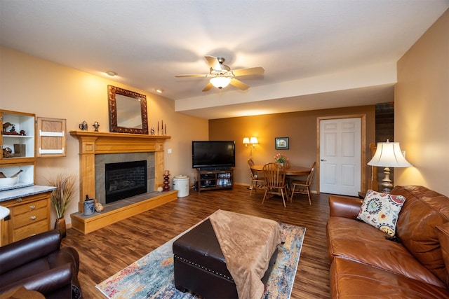 3739 155th Ct, Urbandale, IA 50323 - living room with ceiling fan, a tiled fireplace, wood finished floors, and baseboards