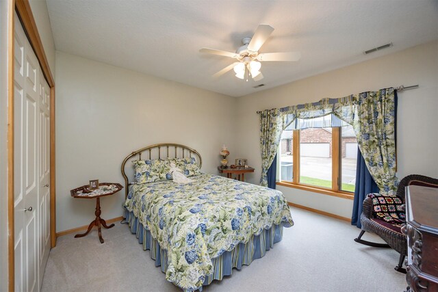 3739 155th Ct, Urbandale, IA 50323 - bedroom with a closet, light carpet, baseboards, and a ceiling fan