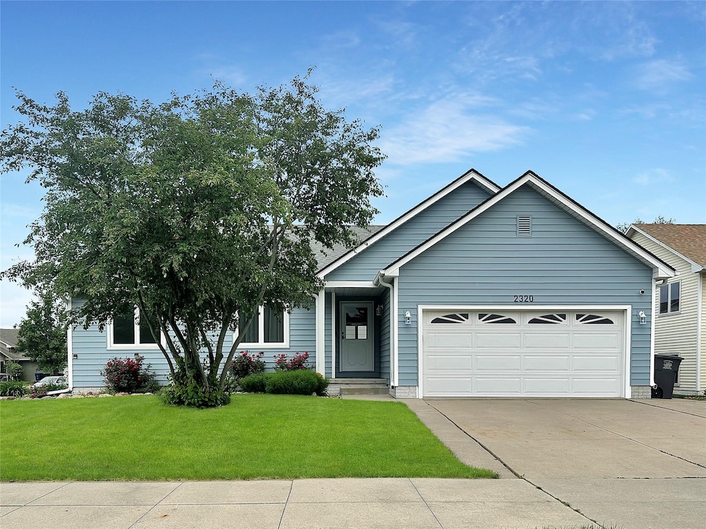 2320 Riverwoods Ave, Des Moines, IA 50320 - view of front of property with an attached garage, a front lawn, and driveway