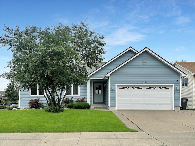 2320 Riverwoods Ave, Des Moines, IA 50320 - view of front of property with an attached garage, a front lawn, and driveway