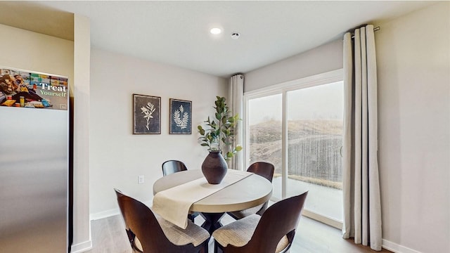 1036 Maple St, Waukee, IA 50263 - dining area featuring light wood-style flooring, baseboards, and recessed lighting