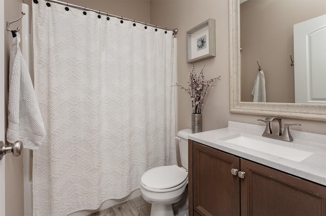 604 SE 18th St, Grimes, IA 50111 - bathroom featuring toilet, vanity, a shower with shower curtain, and wood finished floors