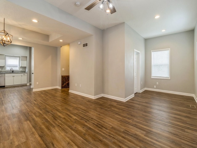 601 S 3rd Ave E, Newton, IA 50208 - unfurnished living room with recessed lighting, healthy amount of natural light, dark wood-type flooring, and baseboards