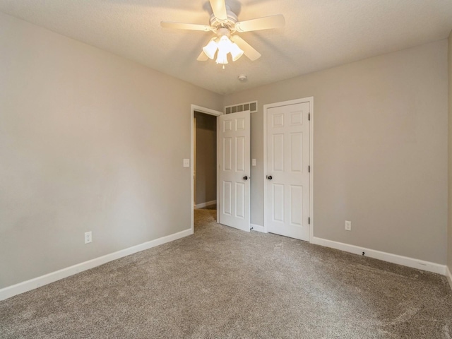 601 S 3rd Ave E, Newton, IA 50208 - unfurnished bedroom with carpet floors, baseboards, and a ceiling fan