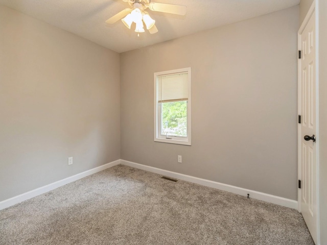 601 S 3rd Ave E, Newton, IA 50208 - spare room featuring carpet flooring, baseboards, and ceiling fan