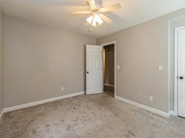 601 S 3rd Ave E, Newton, IA 50208 - unfurnished bedroom featuring carpet floors, baseboards, and ceiling fan