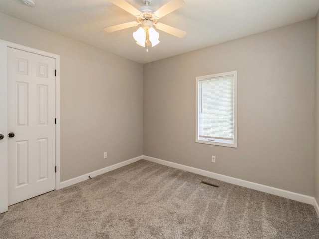 601 S 3rd Ave E, Newton, IA 50208 - carpeted spare room with baseboards and ceiling fan