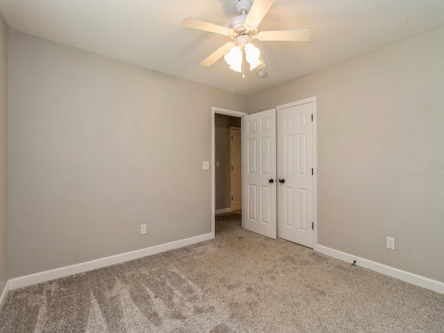 601 S 3rd Ave E, Newton, IA 50208 - unfurnished bedroom featuring carpet, baseboards, ceiling fan, and a closet