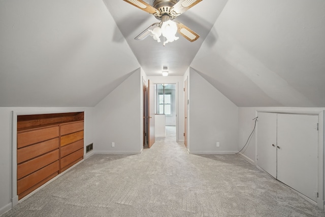 7105 Madison Ave, Urbandale, IA 50322 - additional living space with light carpet, lofted ceiling, ceiling fan, and baseboards