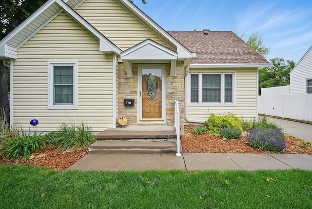 7105 Madison Ave, Urbandale, IA 50322 - bungalow-style home featuring stone siding and a shingled roof