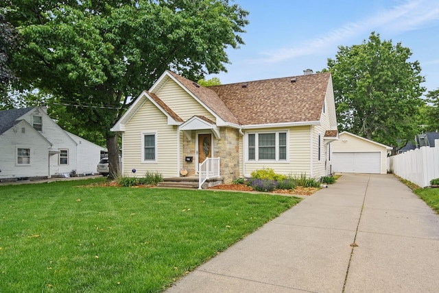 7105 Madison Ave, Urbandale, IA 50322 - bungalow-style house featuring a detached garage, an outbuilding, roof with shingles, and stone siding