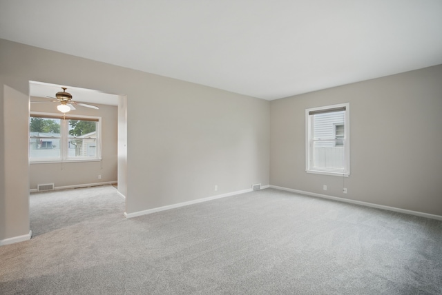 7105 Madison Ave, Urbandale, IA 50322 - spare room with light colored carpet, baseboards, and a ceiling fan