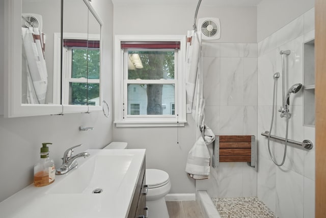 7105 Madison Ave, Urbandale, IA 50322 - full bathroom with a marble finish shower, vanity, and toilet