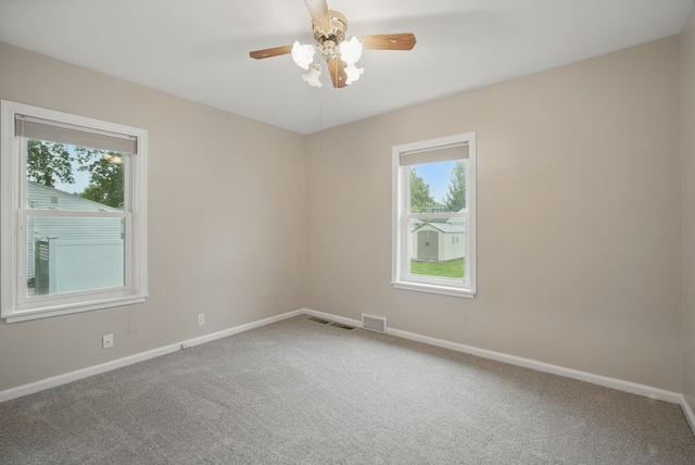 7105 Madison Ave, Urbandale, IA 50322 - carpeted empty room featuring plenty of natural light, baseboards, and a ceiling fan