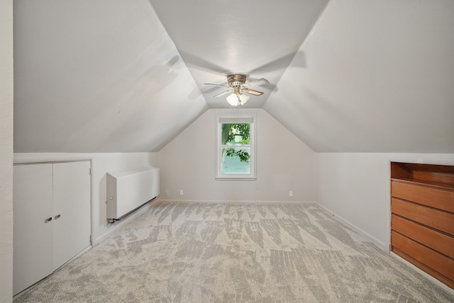 7105 Madison Ave, Urbandale, IA 50322 - additional living space with light colored carpet, ceiling fan, vaulted ceiling, and baseboards