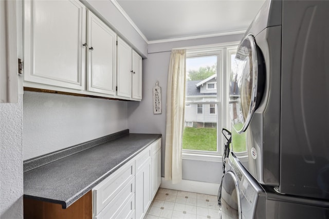 2419 30th St, Des Moines, IA 50310 - laundry room with estacked washer and dryer, cabinet space, and ornamental molding