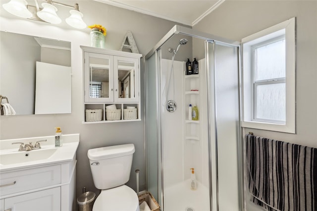 2419 30th St, Des Moines, IA 50310 - full bathroom with a shower stall, vanity, toilet, and crown molding