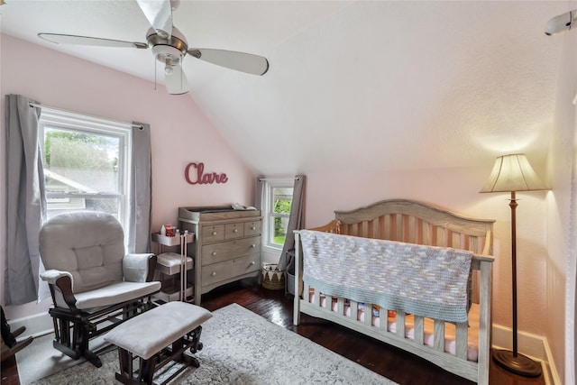 2419 30th St, Des Moines, IA 50310 - bedroom with vaulted ceiling, multiple windows, dark wood finished floors, and ceiling fan