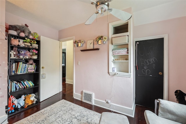 2419 30th St, Des Moines, IA 50310 - living area featuring dark wood-style floors, ceiling fan, and baseboards