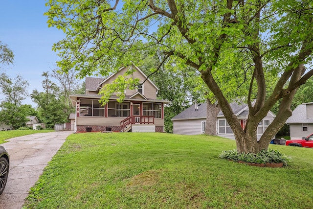 2419 30th St, Des Moines, IA 50310 - view of front of house featuring a sunroom, crawl space, a front yard, roof with shingles, and driveway