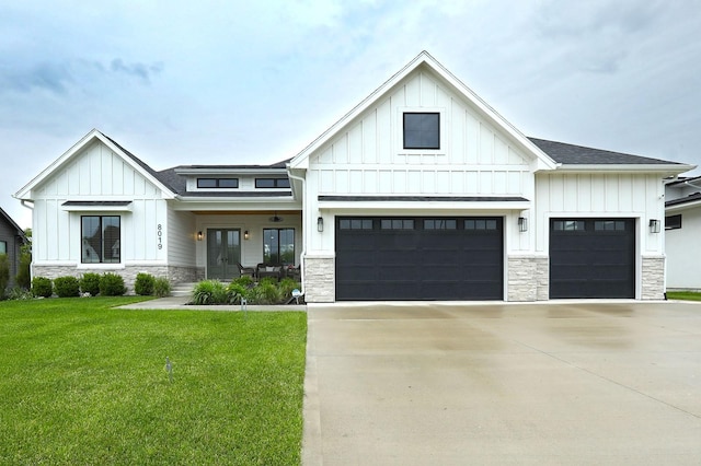 8019 NW 106th Ct, Johnston, IA 50131 - modern inspired farmhouse featuring board and batten siding, stone siding, a front lawn, concrete driveway, and an attached garage