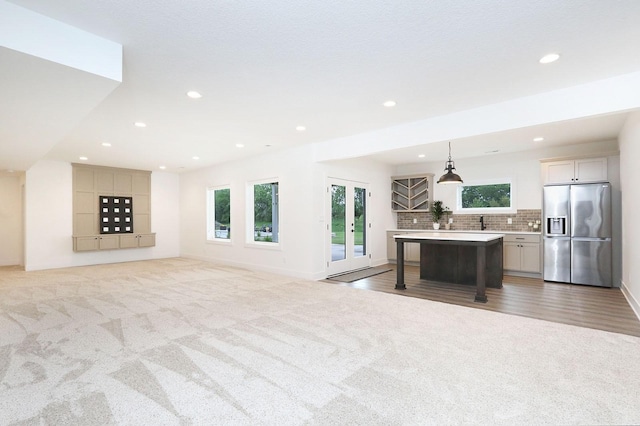 8019 NW 106th Ct, Johnston, IA 50131 - living room with light carpet, recessed lighting, and baseboards