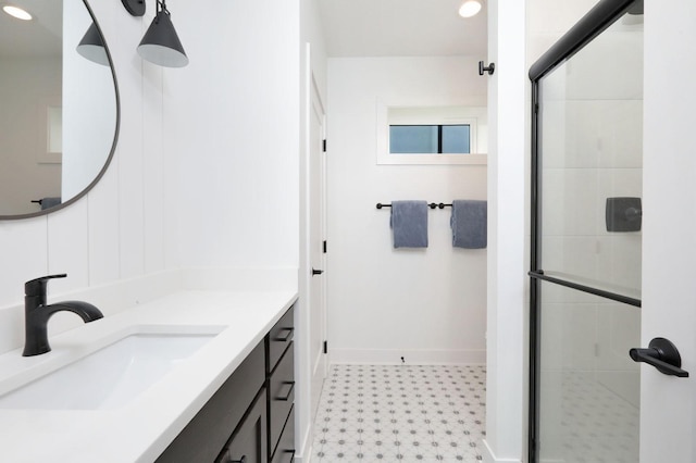 8019 NW 106th Ct, Johnston, IA 50131 - bathroom with tile patterned floors, vanity, a stall shower, baseboards, and recessed lighting