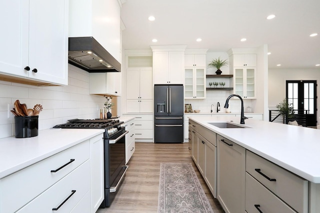 8019 NW 106th Ct, Johnston, IA 50131 - kitchen with high quality fridge, gas range oven, a sink, tasteful backsplash, and light wood-style floors