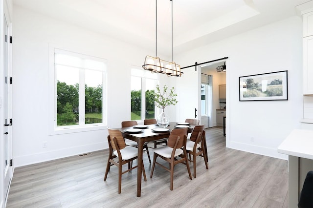 8019 NW 106th Ct, Johnston, IA 50131 - dining room featuring light wood-style floors, baseboards, a barn door, and a chandelier