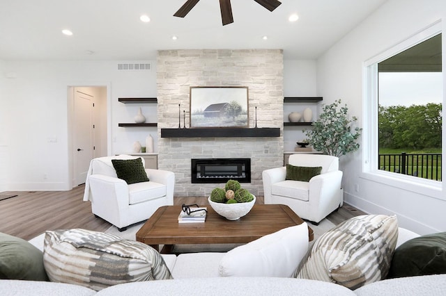 8019 NW 106th Ct, Johnston, IA 50131 - living area with ceiling fan, wood finished floors, a stone fireplace, baseboards, and recessed lighting