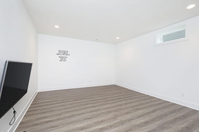 8019 NW 106th Ct, Johnston, IA 50131 - spare room featuring wood finished floors, recessed lighting, and baseboards