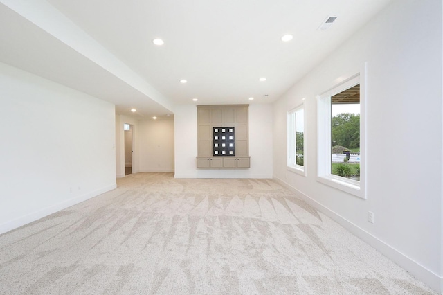 8019 NW 106th Ct, Johnston, IA 50131 - unfurnished living room with recessed lighting, light colored carpet, and baseboards