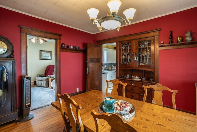 509 2nd Ave, Slater, IA 50244 - dining room featuring a chandelier, crown molding, and light wood-style floors