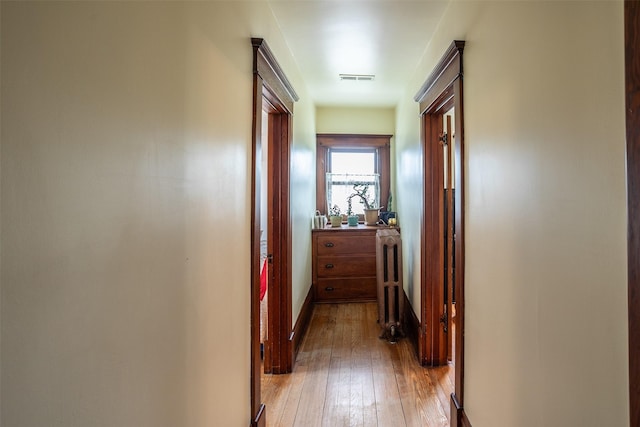 509 2nd Ave, Slater, IA 50244 - hallway with radiator heating unit, light wood-style floors, and baseboards