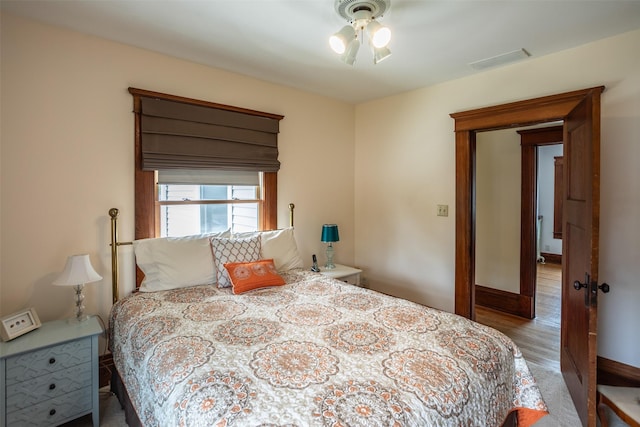 509 2nd Ave, Slater, IA 50244 - bedroom featuring baseboards and wood finished floors