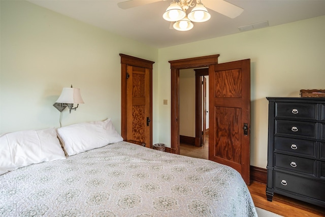 509 2nd Ave, Slater, IA 50244 - bedroom featuring wood finished floors, a ceiling fan, and baseboards