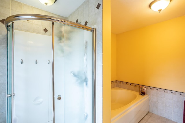 509 2nd Ave, Slater, IA 50244 - bathroom with a stall shower, tile walls, a garden tub, and tile patterned flooring