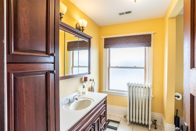 509 2nd Ave, Slater, IA 50244 - bathroom featuring radiator, vanity, baseboards, and tile patterned floors