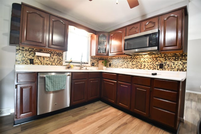 310 Fleming Rd, Carlisle, IA 50047 - kitchen featuring stainless steel appliances, light countertops, light wood-type flooring, and a ceiling fan