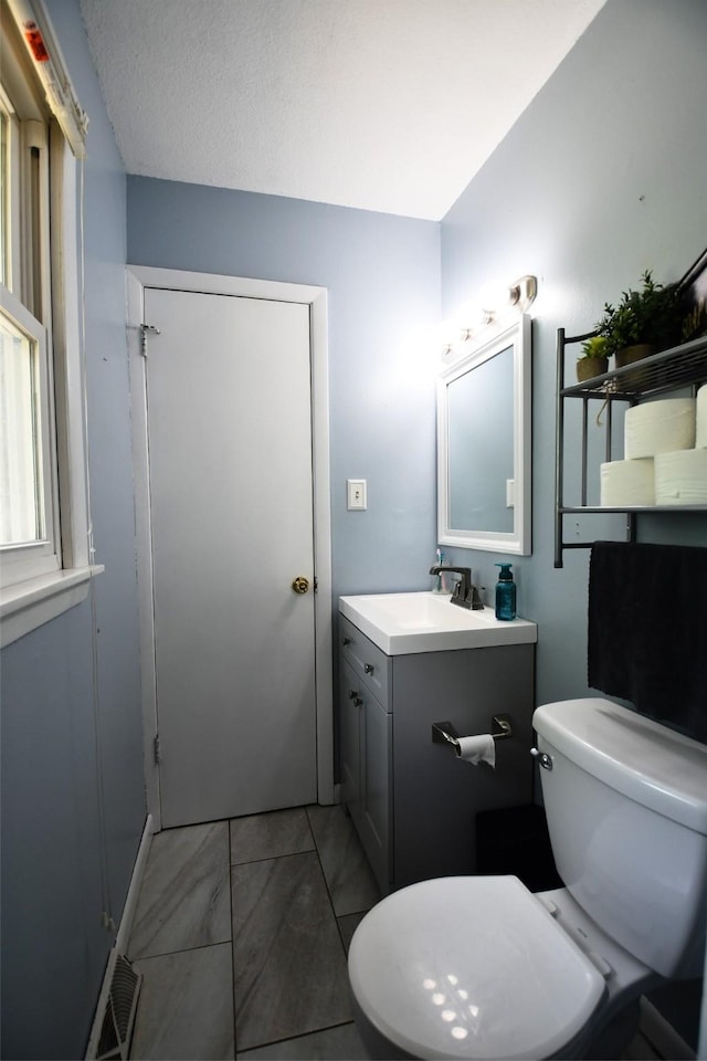 310 Fleming Rd, Carlisle, IA 50047 - bathroom featuring vanity and toilet