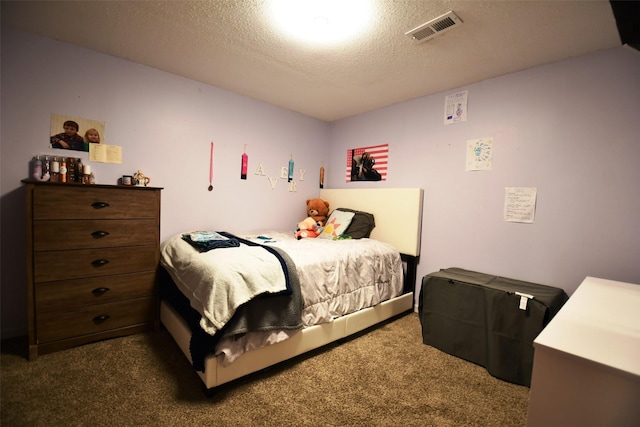 310 Fleming Rd, Carlisle, IA 50047 - bedroom with dark colored carpet and a textured ceiling