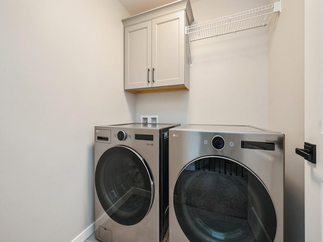 4813 Preston Ln, Iowa City, IA 52246 - laundry room featuring separate washer and dryer, cabinet space, and baseboards