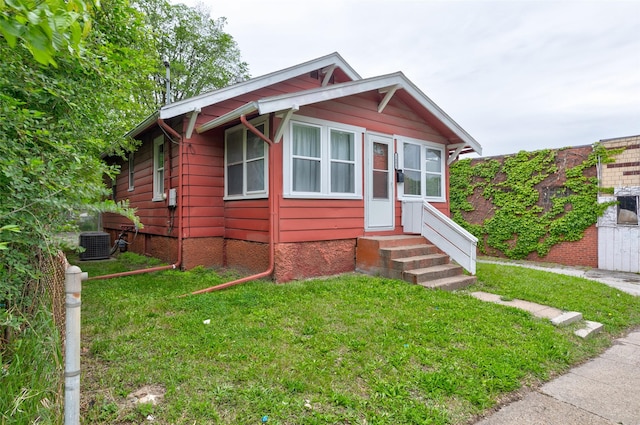 2403 E 14th St, Des Moines, IA 50316 - bungalow featuring entry steps, a front yard, and central air condition unit
